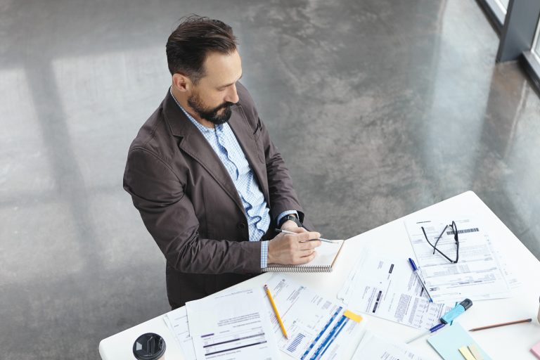 Professional expert reviewing a construction estimate to identify hidden costs and protect homeowners.